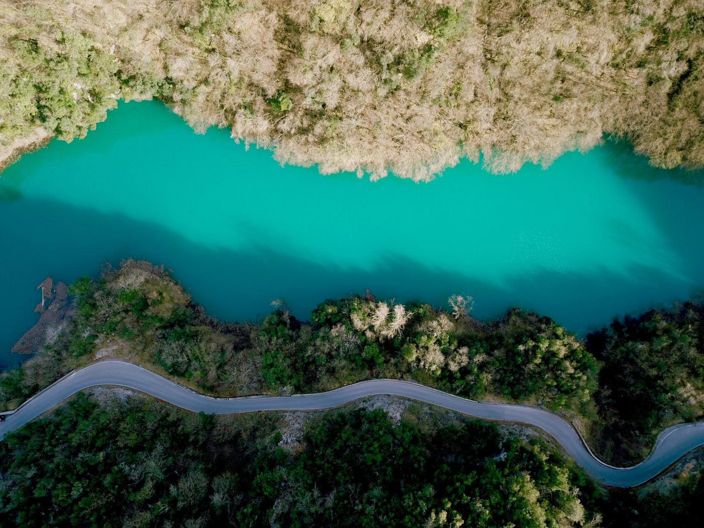 Aerial view of a turquoise river and road